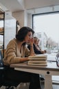 Woman working in an office, discussing business strategies and finding innovative solutions. She works on a project