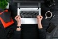 Woman working at the office table. Top view of human hands, laptop keyboard, a cup of coffee, smartphone, notebook and a Royalty Free Stock Photo