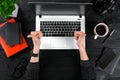 Woman working at the office table. Top view of human hands, laptop keyboard, a cup of coffee, smartphone, notebook and a Royalty Free Stock Photo