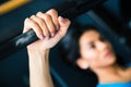 Woman working out with barbell. Focus on barbell