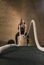 Woman working out with battle ropes Royalty Free Stock Photo