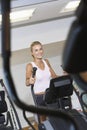 Woman Working Out On Elliptical Machine