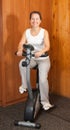 Woman working out on exercycle at home Royalty Free Stock Photo