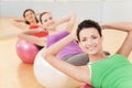 Woman working out in gym doing pilates.