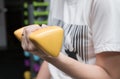 Woman working out with holding yellow barbell dumbbell at fitness gym