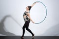 Woman working out with hoola hoop in studio. Royalty Free Stock Photo