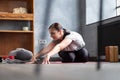 Woman working out indoors, doing variation of twisted forward bend yoga exercise Royalty Free Stock Photo