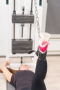 Woman working out legs on cable machine at gym Royalty Free Stock Photo