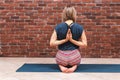 Woman working out in loft interior on brick wall background with copy space, doing asana exercises, Vajrasana Pashima Royalty Free Stock Photo