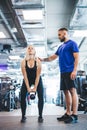 Woman working out with personal trainer at a gym. Royalty Free Stock Photo