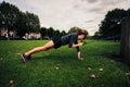 Woman working out with resistance band in the park Royalty Free Stock Photo