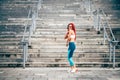 Woman working out and running. Caucasian woman smiling and laughing while doing cardio training