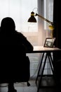 Woman working on PC at home silhouette