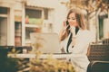 Woman working with a phone and laptop Royalty Free Stock Photo