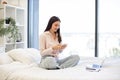 Woman working remotely from home, typing on modern wireless cell phone. Royalty Free Stock Photo