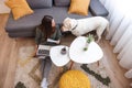 Woman working remotely from home using laptop computer with her pet dog Royalty Free Stock Photo