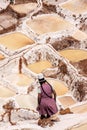 Woman working at salt pans of Cusco