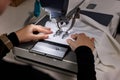 Woman working with sewing machine in professional workshop, closeup Royalty Free Stock Photo
