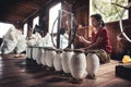 Woman working, sitting on the ground, the lotus thread. Royalty Free Stock Photo