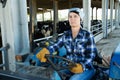 woman working on small farm tractor Royalty Free Stock Photo