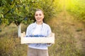 Woman working on sorting line at fruit warehouse, stacking boxes with selected plums. Royalty Free Stock Photo