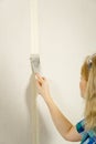 Woman putty plaster. Builder female indoor worker plastering wall with spatula trowel tool