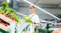 Woman working in a supermarket sorting fruit and vegetables Royalty Free Stock Photo