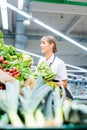 Woman working in a supermarket sorting fruit and vegetables Royalty Free Stock Photo