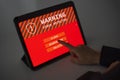 Woman working with tablet with virus warning notification on screen and is choosing a management method from the options clean, Royalty Free Stock Photo