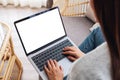 A woman working and typing on laptop computer with blank screen while sitting on a sofa at home Royalty Free Stock Photo