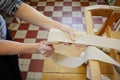 Woman working in upholstery workshop with webbing stretcher. Royalty Free Stock Photo