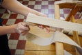 Woman working in upholstery workshop with webbing stretcher. Royalty Free Stock Photo