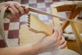 Woman working in upholstery workshop with webbing stretcher. Royalty Free Stock Photo