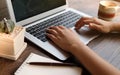 A woman is working by using a laptop computer on table. Hands ty Royalty Free Stock Photo