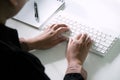 Woman working by using a laptop computer on wooden table. Hands typing on a keyboard Royalty Free Stock Photo