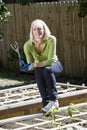 Woman working on vegetable garden in backyard Royalty Free Stock Photo