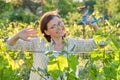 Woman working with vine bushes, spring summer pruning vineyard