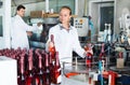 Woman working on wine production on manufactory