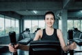 Woman workout elliptical trainer exercise in fitness gym., Portrait of pretty attractive caucasian woman doing elliptical trainer Royalty Free Stock Photo