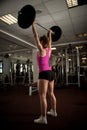 Woman workout in fitness gym with barbells - powerlift workout