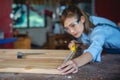 Woman works in a carpentry shop. Carpenter working on woodworking machines in carpentry shop Royalty Free Stock Photo