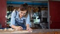 Woman works in a carpentry shop. Carpenter working on woodworking machines in carpentry shop Royalty Free Stock Photo