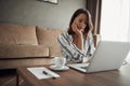 Woman works for a computer from a home with a laptop as a freelancer Royalty Free Stock Photo