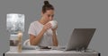 Woman works freelance in studio, she uses her laptop at the table