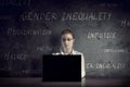 Woman works at her desk in a dark room.