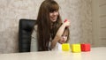 Woman works at home with a child. quarantine coronavirus. mother plays with her child in multi-colored cubes at work in