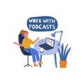 A woman works in an office and listens to a podcast.