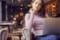 Woman works remotely online from cafe while quarantine coronavirus is in effect. Concept of checking mail, blogger, freelancer