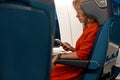 Woman works from a train with a phone during her ride to the business meeting in the evening.