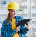 Woman in workshop with drilling drill